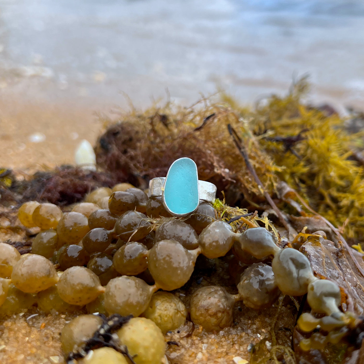 Blue sea glass set in silver on a cast driftwood inspired silver ring band by Mornington Sea Glass. Size 8 1/2