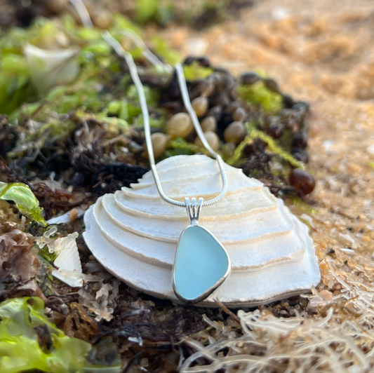 Soft blue sea glass set in silver pendant by Mornington Sea Glass. Hangs on 40cm or 45cm sterling silver snake chain.