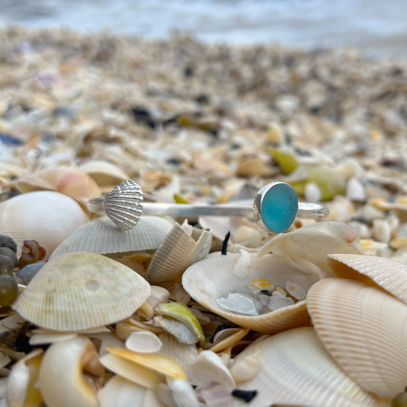 Ocean teal sea glass set in silver cuff and cast shell charm cuff by Mornington Sea Glass.