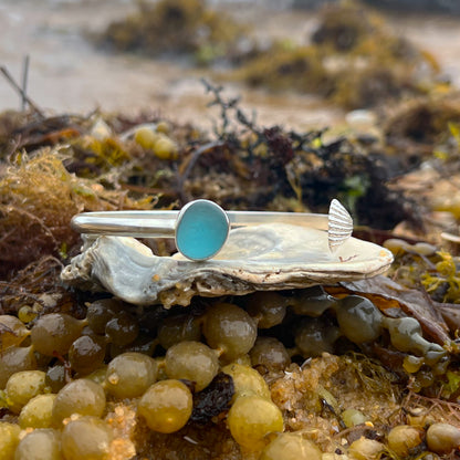 Ocean teal sea glass set in silver cuff and cast shell charm cuff by Mornington Sea Glass.