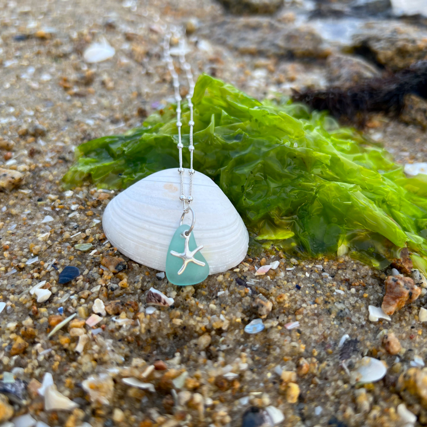 Aqua blue sea glass and silver sea star pendant by Mornington Sea Glass. Hangs on a 40cm +5cm ext ball detail chain.