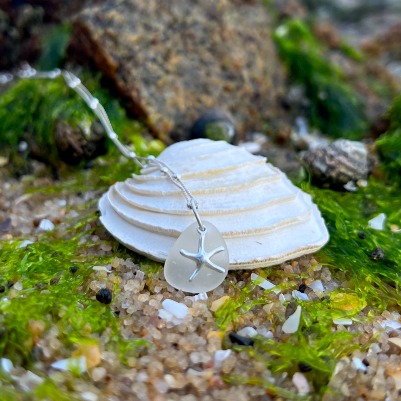 White sea glass and silver sea star pendant  by Mornington Sea Glass. Hangs on a 40cm sterling silver ball detail chain with 5cm extension.