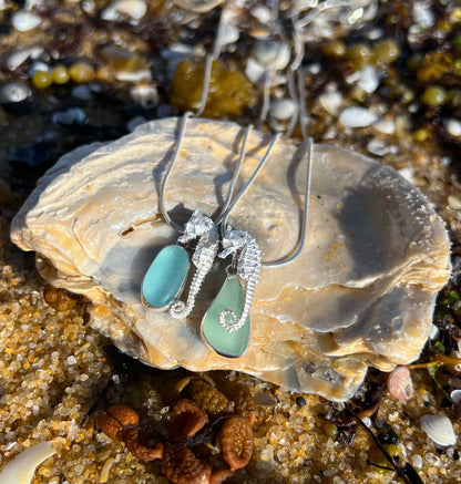 Sterling silver necklaces of small cast silver seahorses with  sea glass treasure charms. Hangs on a 40 or 45cm sterling silver chain. By Mornington Sea Glass.