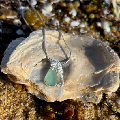 Sterling silver necklace of a small cast silver seahorse with  seafoam sea glass treasure. Hangs on a 40 or 45cm sterling silver chain. By Mornington Sea Glass.