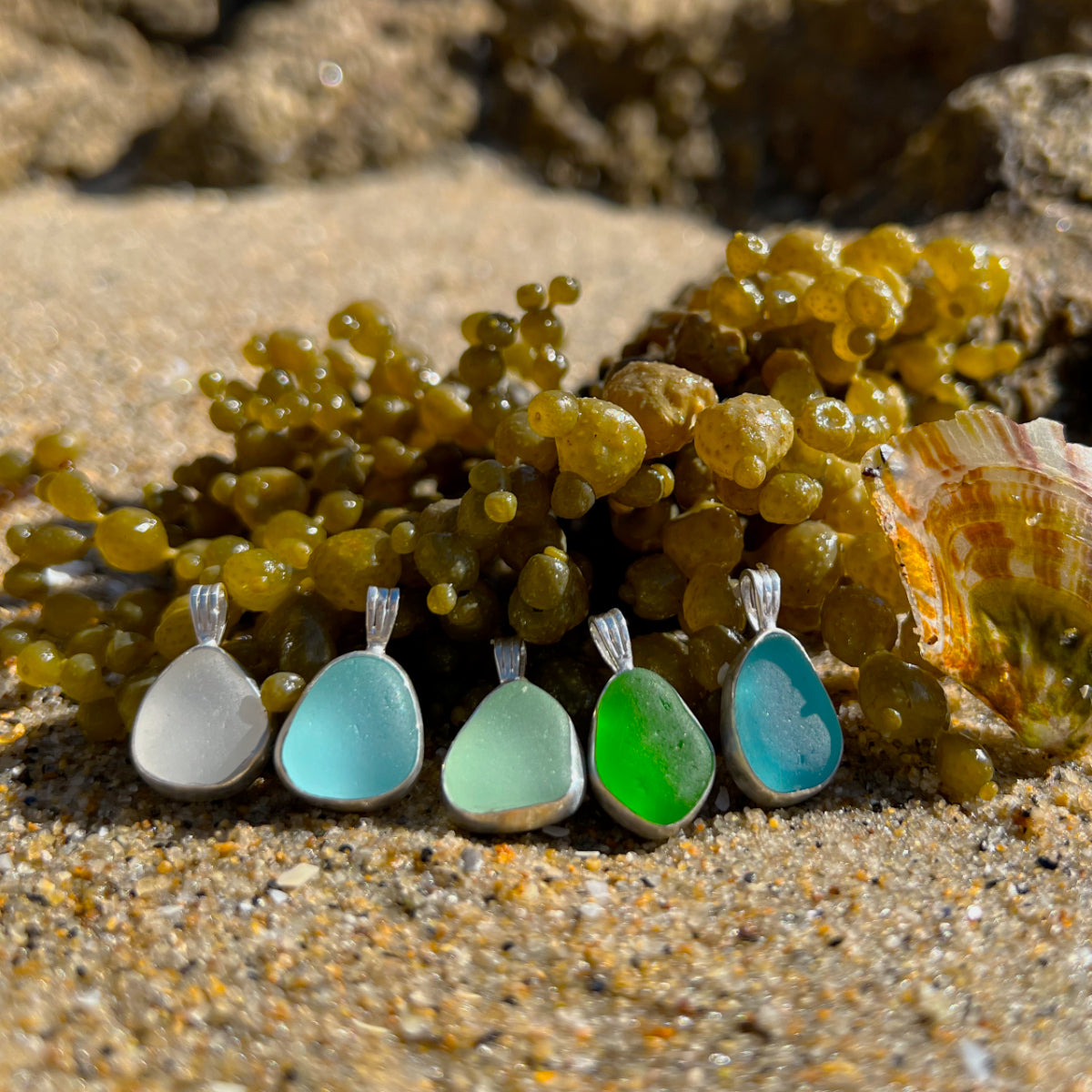 Sea glass set in silver pendants by Mornington Sea Glass.